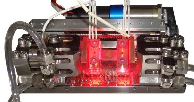 microtester with red hot heated grips performing a tensile test