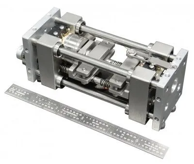 small material testing machine with a 6 inch ruler for scale